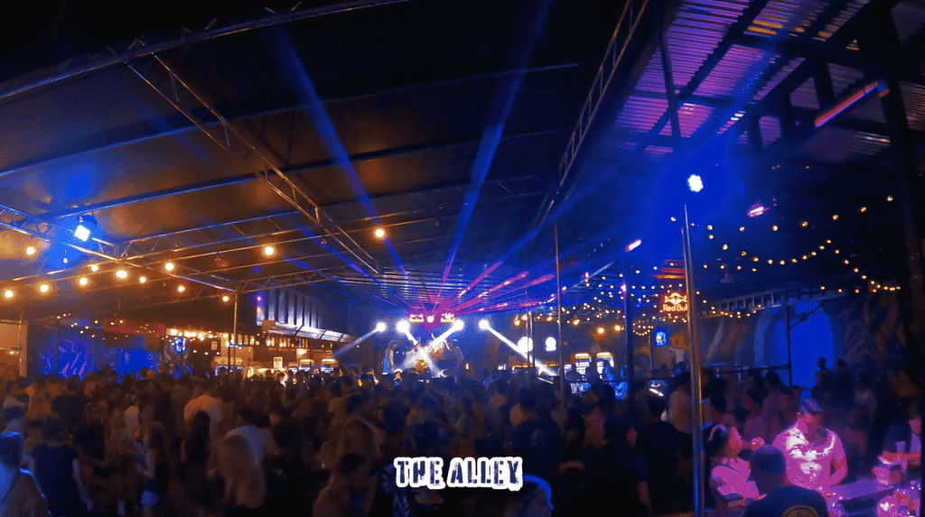 Vibrant dance club in Tamarindo with lively crowd, dynamic lights, and energetic atmosphere.