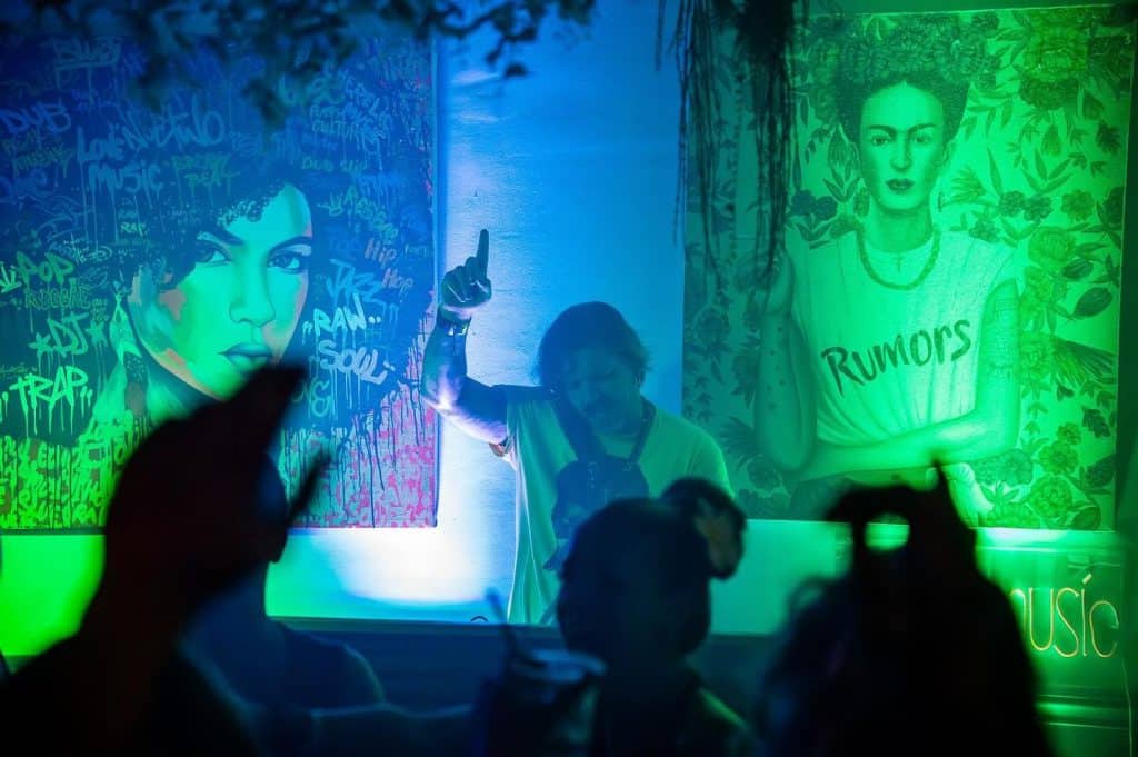Colorful mural art featuring iconic portraits at Tamarindo nightlife event.