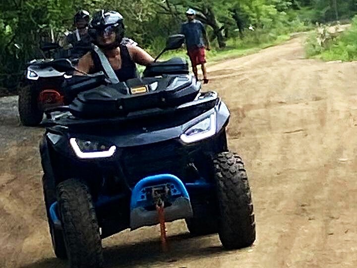 atv rider on shaded jungle road