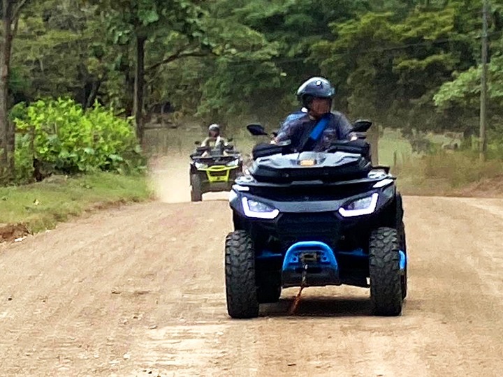 atv riders approaching on dirt road
