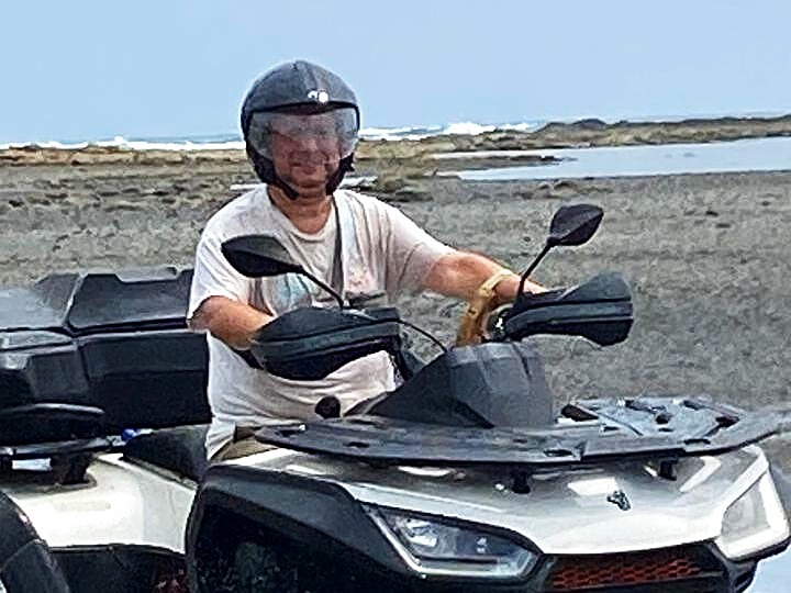 rider on atv at the beach