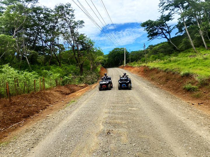 two atvs on country road