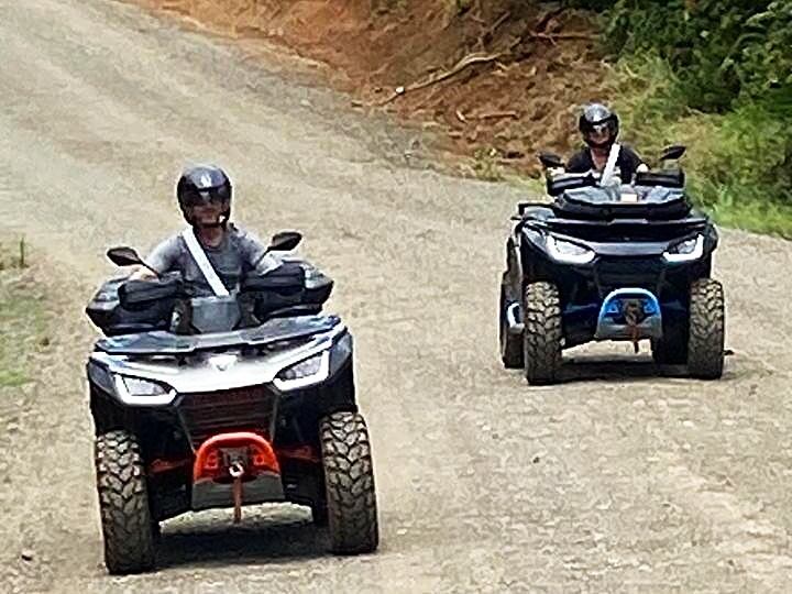 two riders descending dirt road