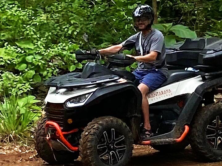 young rider on atv jungle trail