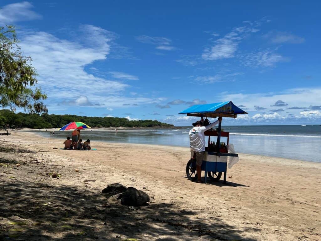 Beach vendor with a pushcart on the sand at Tamarindo Beach
