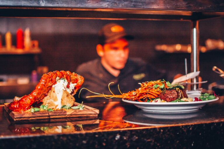 dragonfly bar grill chef plating at kitchen pass 1 768x512