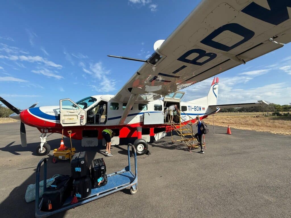 Sansa Cessna Caravan with a luggage cart on the Tamarindo airstrip